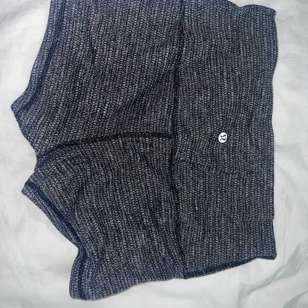 Speckled-like texture blackish/greyish
& white-ish. Lululemon “booty shorts”.